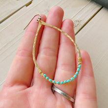 Load image into Gallery viewer, Hammered brass teardrops wirewrapped with turquoise colored beads
